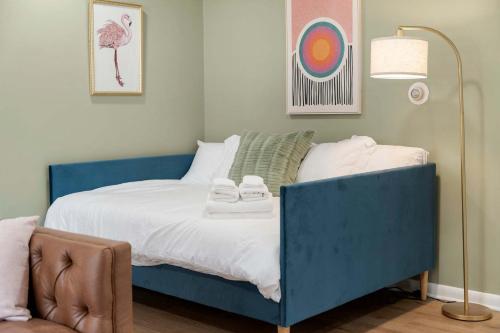 a bedroom with a blue bed with towels on it at Free Parking Workdesk King Bed in Lombard