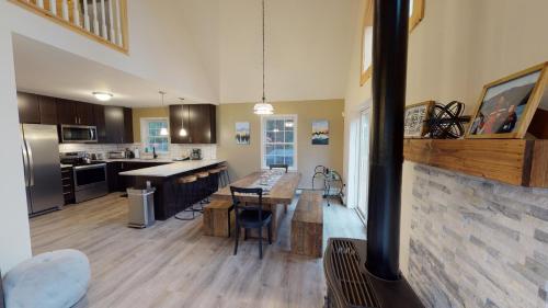 a large kitchen with a table and a stove at The Mendon House in Killington