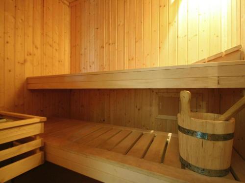 a wooden sauna with a wooden chair in it at Ferienhaus An de Linn, Nakenstorf in Nakensdorf