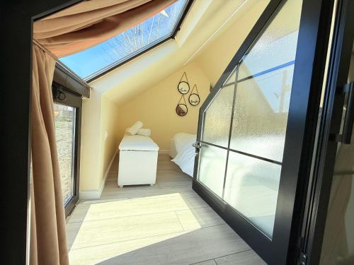 a room with a glass door and a window at 446 Tiny House Zues in Shkodër
