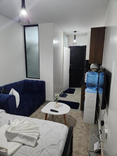 a small living room with a couch and a table at Comfort and charm in Nairobi