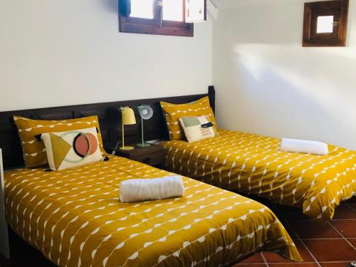 two beds sitting next to each other in a room at Hamlets Friends Rural House in Nuño Gómez