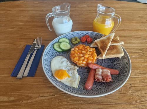 a plate of breakfast food with eggs beans and toast at Casa Castillo in Huércal-Overa