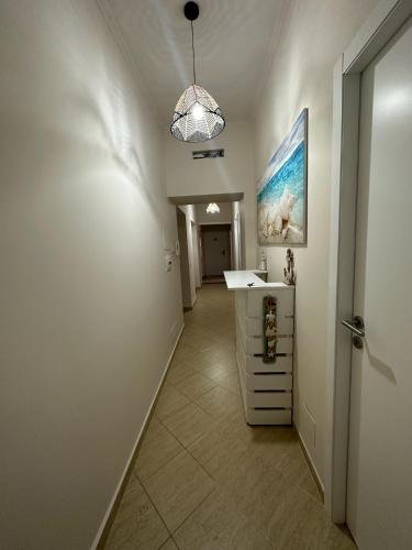 a hallway with a sink and a desk in a room at River View in Fiumicino
