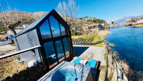 a house with a view of a river at 446 Tiny House Zues in Shkodër
