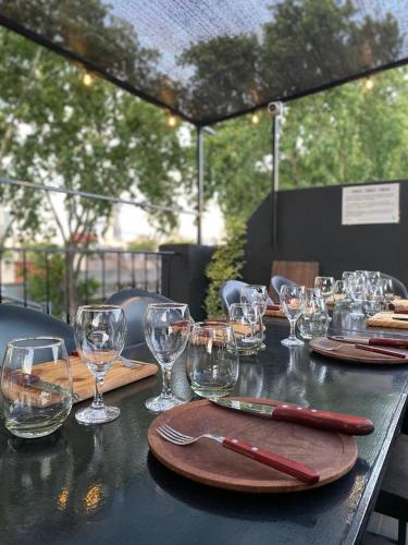 a table with wine glasses and napkins on it at PH Palermo Hostel in Buenos Aires