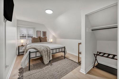 a white bedroom with a bed and a window at NEW! Modern Retreat Near CLE-Game Room-Renovated in Berea