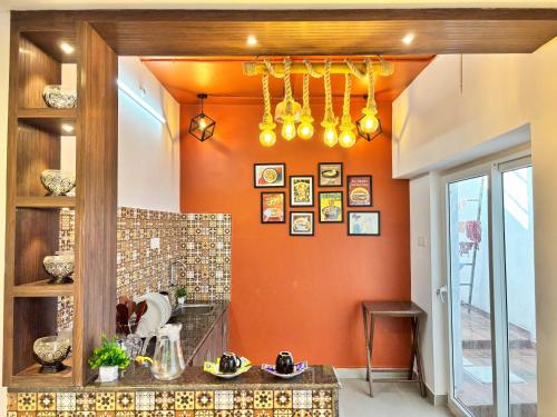 a kitchen with orange walls and a counter top at Ta Cabana Beach house-Pondicherry in Pondicherry
