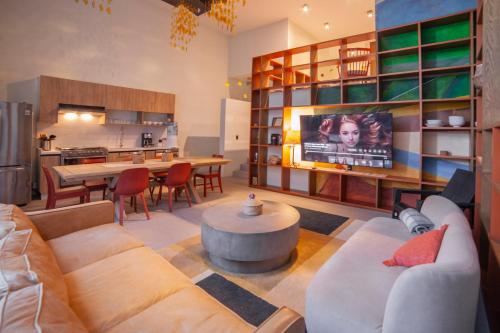 a living room with a couch and a table and a kitchen at Casa Clemente in San Miguel de Allende