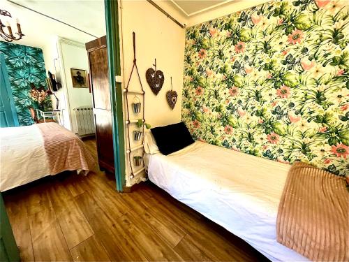 a bedroom with a bed with a floral wallpaper at Riojania Heredad in Santa Eulalia Bajera