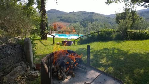 a fire pit in a yard with a pool at Podere Campriano Winery Adult only in Greve in Chianti