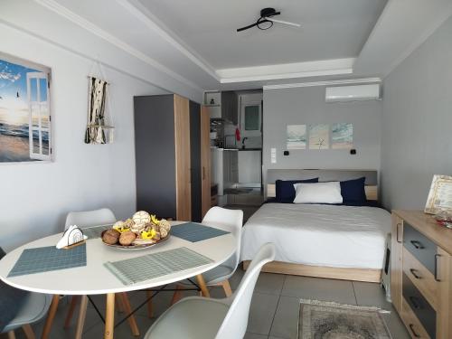 a bedroom with a bed and a table with a plate of fruit at Anatoli in Agia Ermioni