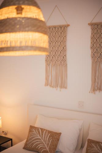 a bedroom with a bed and two windows with curtains at Guesthouse Tamara in Lovište