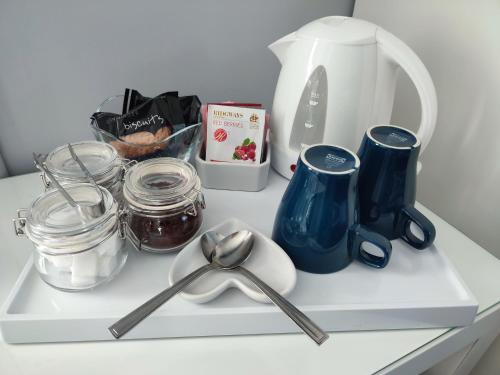 a shelf with utensils and other kitchen items on it at Blue Waters Lodge in Paignton