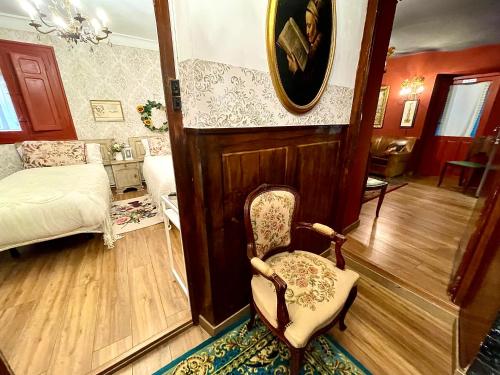 a living room with a chair and a bed at Riojania Heredad in Santa Eulalia Bajera