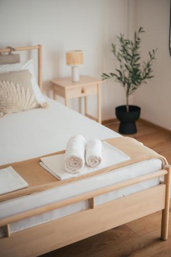 a bed with a tray with towels on it at Guesthouse Tamara in Lovište
