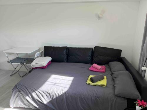 a large couch with two slippers and a table at Souterrain Wohnung in Vellmar bei Kassel in Vellmar