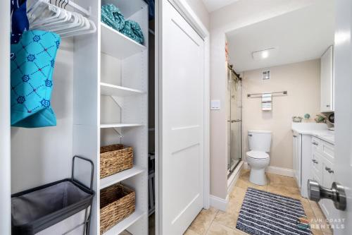 a small bathroom with a toilet and a sink at Spectacular Ocean View STEPS from the Beach and Pool! Third Floor Studio! in Edgewater