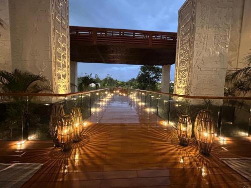 a walkway with lights on a bridge at Hotel Mundo Maya Edzná in Nohyaxché