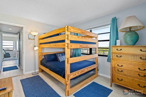 a bedroom with a bunk bed and a dresser at Beachfront 4th Floor Condo with Spectacular Beach & Ocean Views and Pool! in Bottle Island