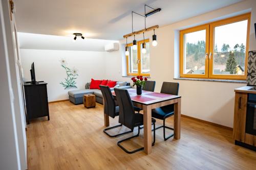 a dining room and living room with a table and chairs at Pr Štepiherju in Luče