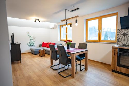 a living room with a table and a couch at Pr Štepiherju in Luče