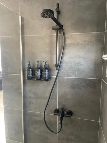 a shower with a shower head in a bathroom at LaKadisa pe Lac in Porumbacu de Jos