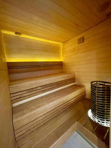 a sauna with wooden paneling and a heater at Magnolia House with Indoor Swimming Pool and Sauna in Tallinn
