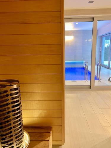 a room with a wooden wall and a table at Magnolia House with Indoor Swimming Pool and Sauna in Tallinn