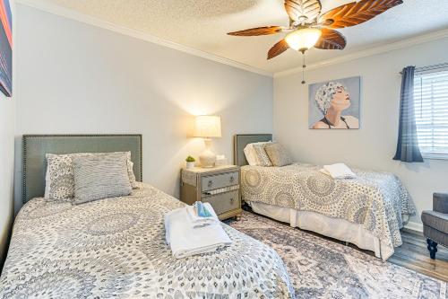 a bedroom with two beds and a ceiling fan at On-The-Beach Escape Oceanfront in Surfside! in Myrtle Beach