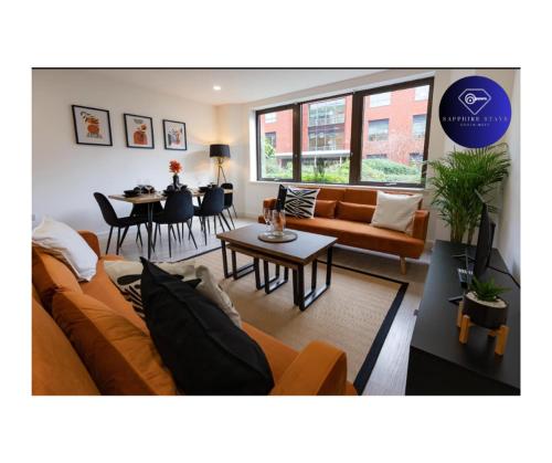 a living room with a couch and a table at Modern City Centre Apartment in Exeter