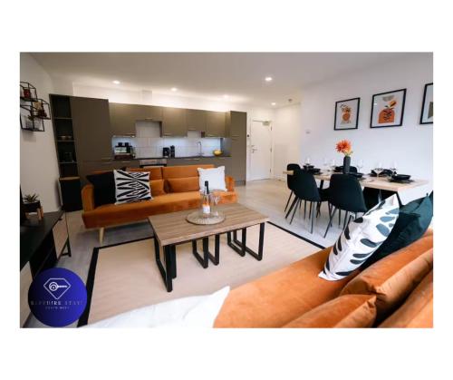 a living room with a couch and a table at Modern City Centre Apartment in Exeter