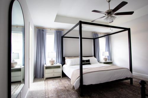 a bedroom with a canopy bed and a ceiling fan at Luxury 5-Star Retreat - Family & Pet Friendly in Southaven