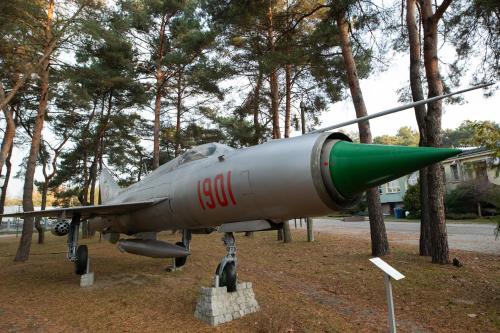 a fighter jet on display in front of trees at Hotel Wilga by Katowice Airport in Pyrzowice