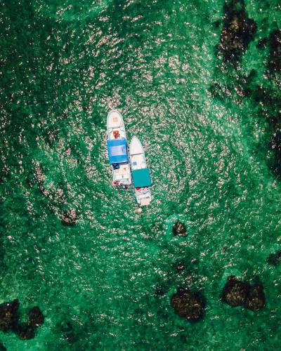 an aerial view of a boat in the water at Hotel Cielo y Selva in Punta Allen