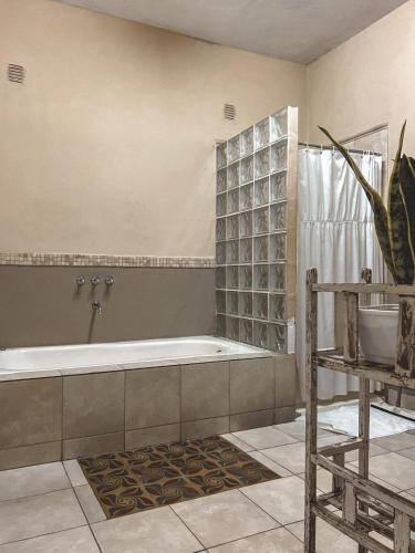 a bathroom with a tub and a sink at Posada Niña Juana in Villa Dolores