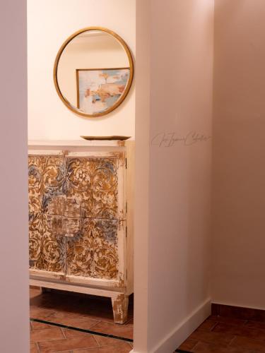 a mirror on a wall next to a fireplace at El Trastero Suite in Montellano
