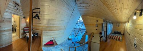 a large wooden building with a staircase in a room at Escaper at Nereju Star Place in Carşocheşti
