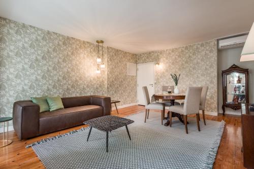 a living room with a couch and a table at Almada Charm Suites & Apartments in Porto