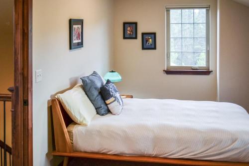 a bedroom with a bed with pillows and a window at Luxury condo with stunning views! in Fraser