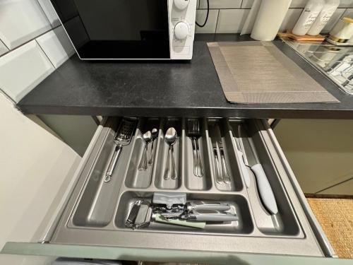 a kitchen sink with utensils in it at Town centre 1 Cozy king size bed ensuit shower in Huntingdon