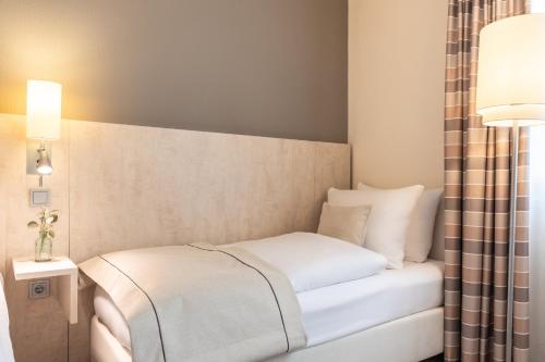 Ένα ή περισσότερα κρεβάτια σε δωμάτιο στο Garner Hotel Mainz by IHG