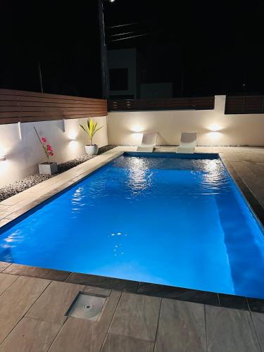 a swimming pool at night with blue lighting at Casa Blue Print Mahebourg in Mahébourg