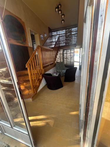 a hallway with a staircase and chairs in a house at Royal castle Fruska gora in Prnjavor