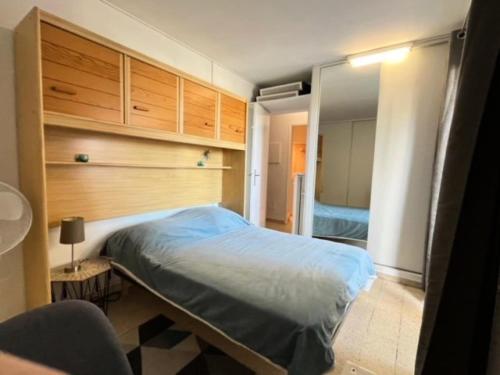 - une chambre avec un lit, des armoires et un miroir dans l'établissement Résidence Port Royal - Appartement 6 couchages au centre du Grau du roi MAE-9831, au Grau-du-Roi
