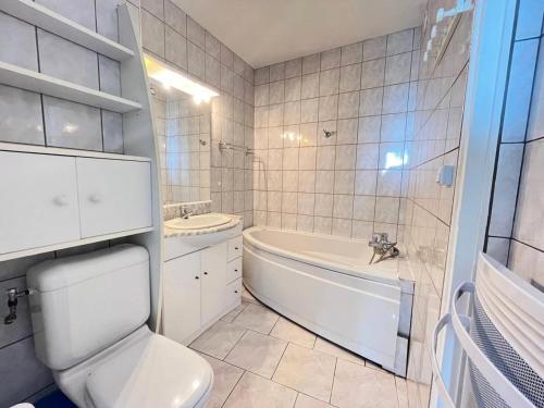 une salle de bain avec toilettes, baignoire et lavabo dans l'établissement Résidence Le Chabian - Appartement 8 couchages au Grau du roi MAE-9851, au Grau-du-Roi