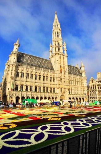 a large building with a clock tower on top of it at Heart of Brussels Escape, Steps from Bourse in Brussels