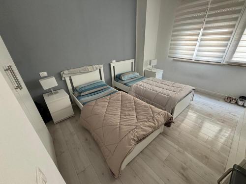 two beds in a room with two tables and a window at Homes in Ancona CCA23 Rooms in Ancona