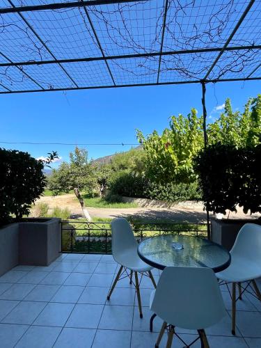 a table and chairs on a patio with a view at Stalaktites Studios in Sami