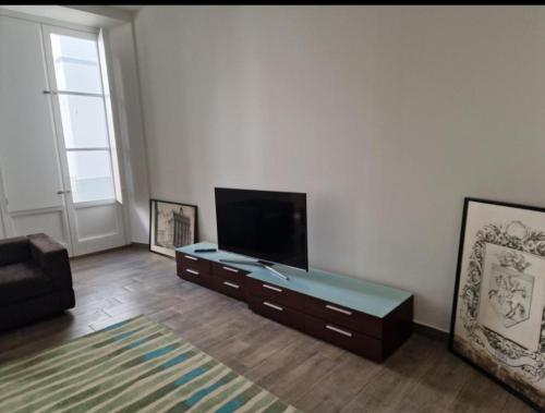 a living room with a flat screen tv and a couch at Casa do Leão II in Évora